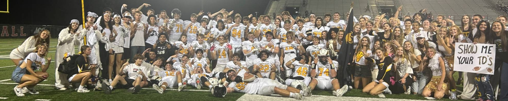 2025 Football Team celebrating a win over Loveland.