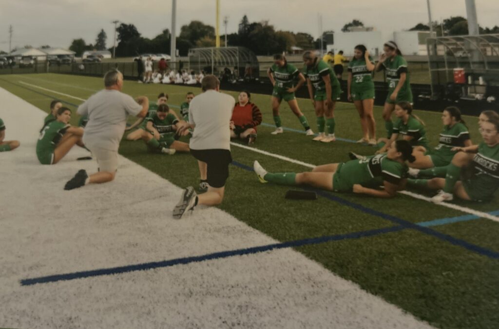 Photo of Chad Phippen speaking to his student-athletes.
