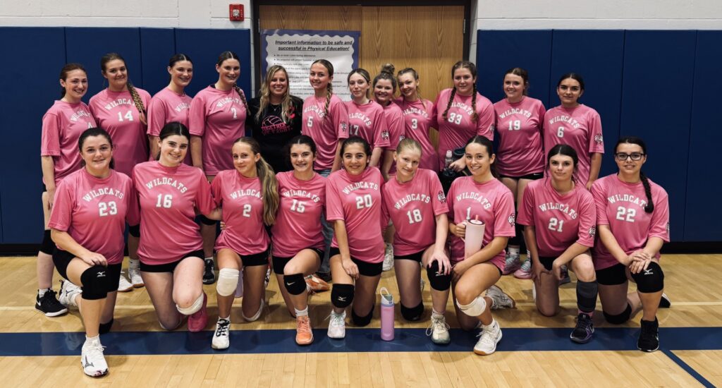 Photo of coach Leesa Isereau pictured with her JV volleyball team.