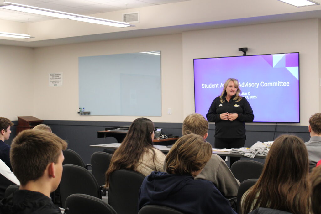 Female adult presenting to a group of high school students