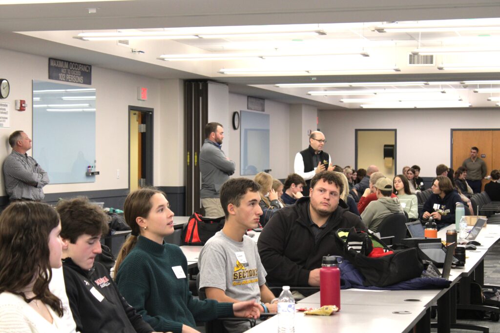 High school students and adults having group discussions