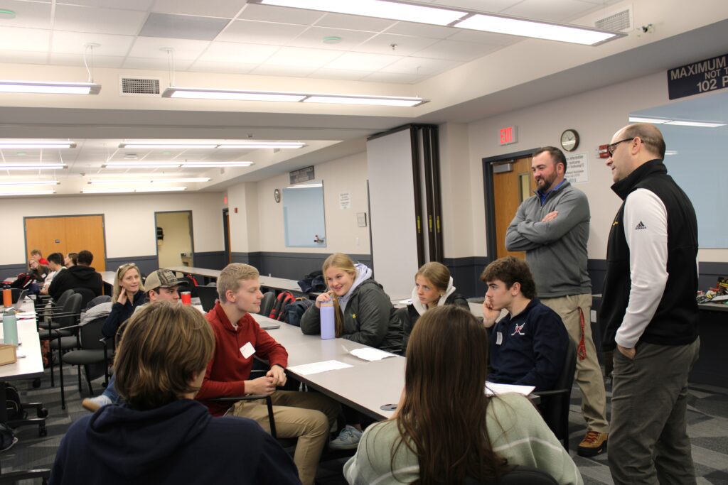 High school students and adults having a group discussion