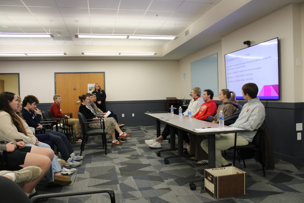 High school students listening to panel discussion with college students and adults