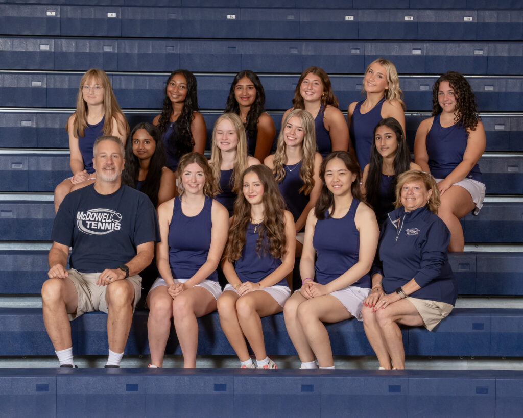 The McDowell girls tennis team poses for a team photo on the bleachers in the McDowell Gym.
