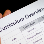 Image shows a hand holding a document that reads Curriculum Overview