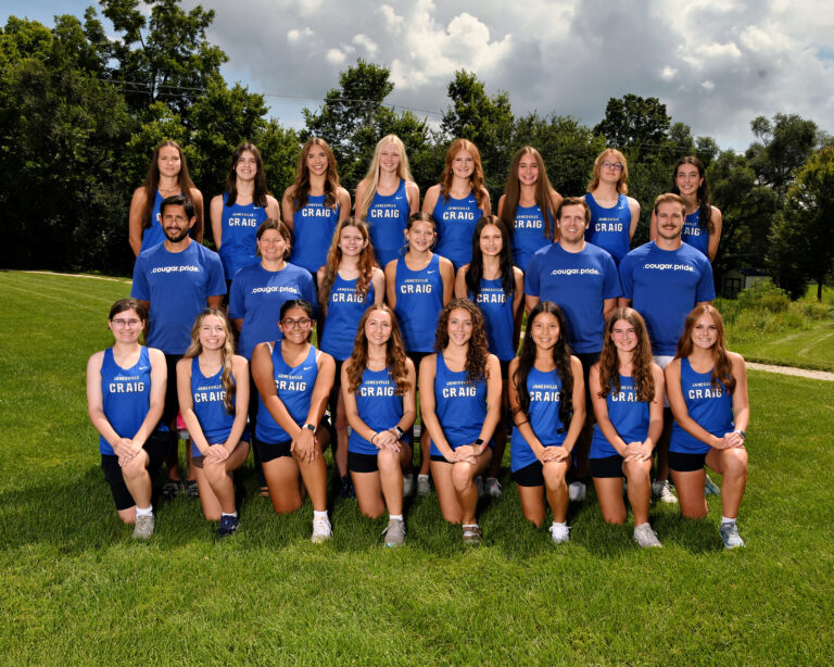 Craig High School girls cross country team dressed and posed wearing blue uniforms