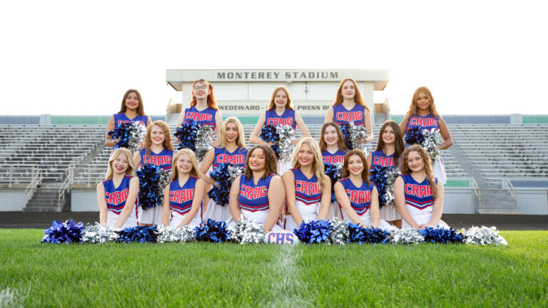 Poms team Picture, girls dressed in poms uniforms posed with their poms at Monterey Stadium
