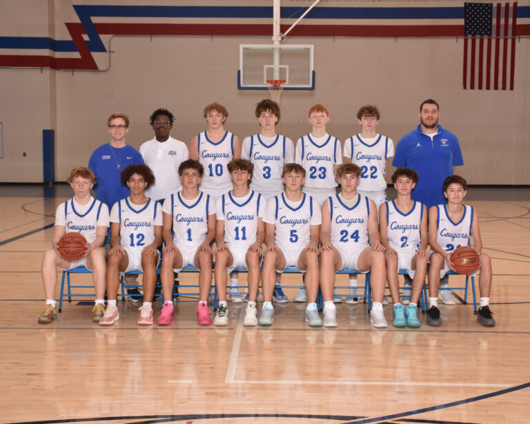 JV Boys Basketball Players in white uniforms