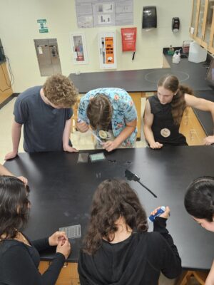 7 Janesville Research Institute students are using supplies to run tests