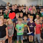 High School Students reading to Elementary Students