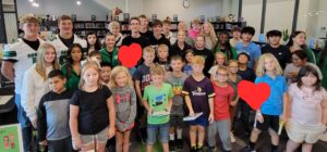 High School Students reading to Elementary Students