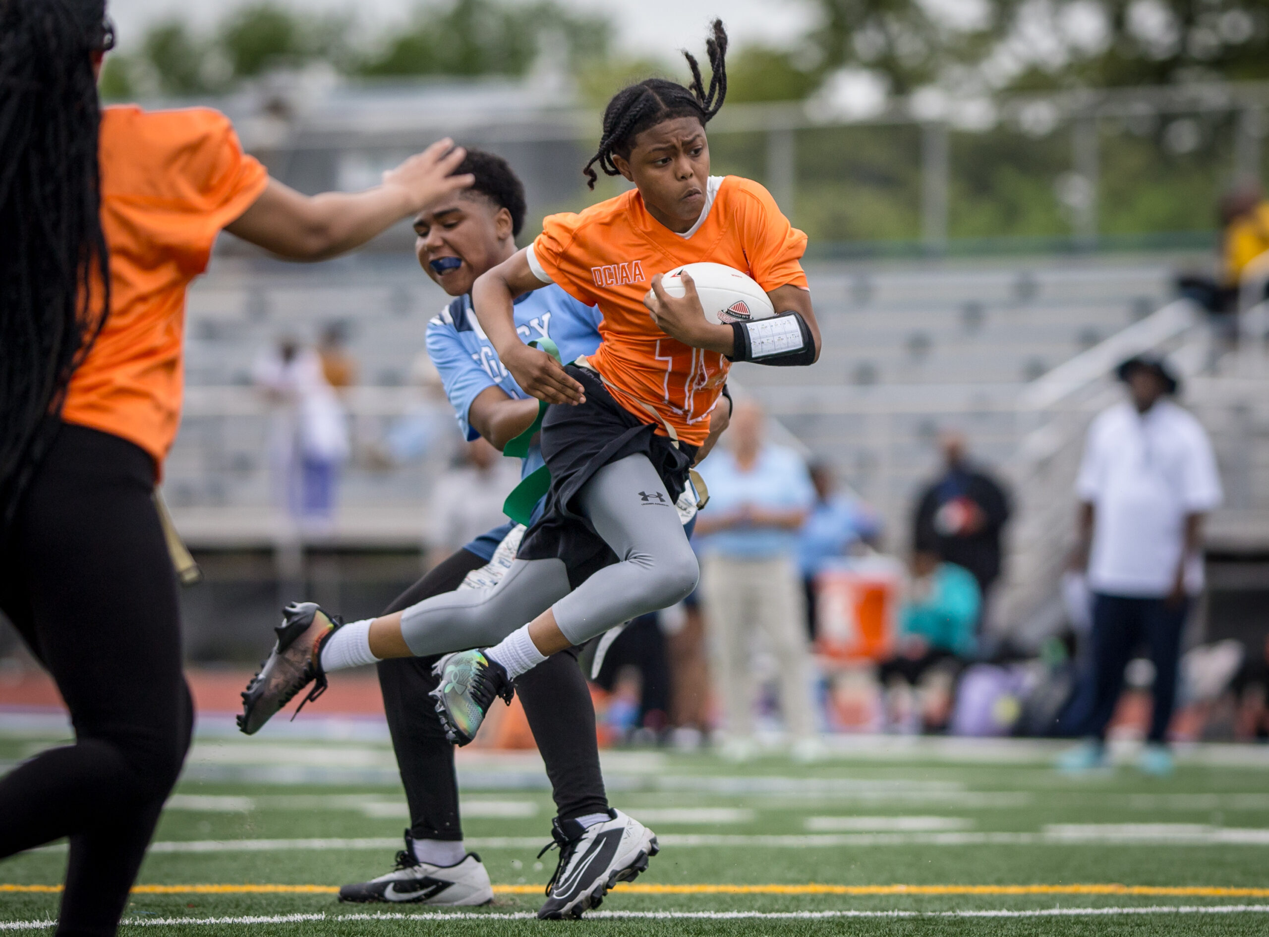 Girl running with football