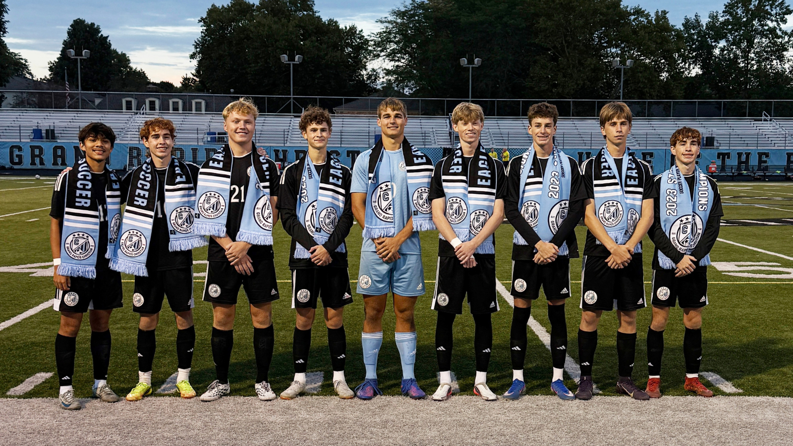 9 Grand Rapids Christian High School soccer seniors standing together on senior night.